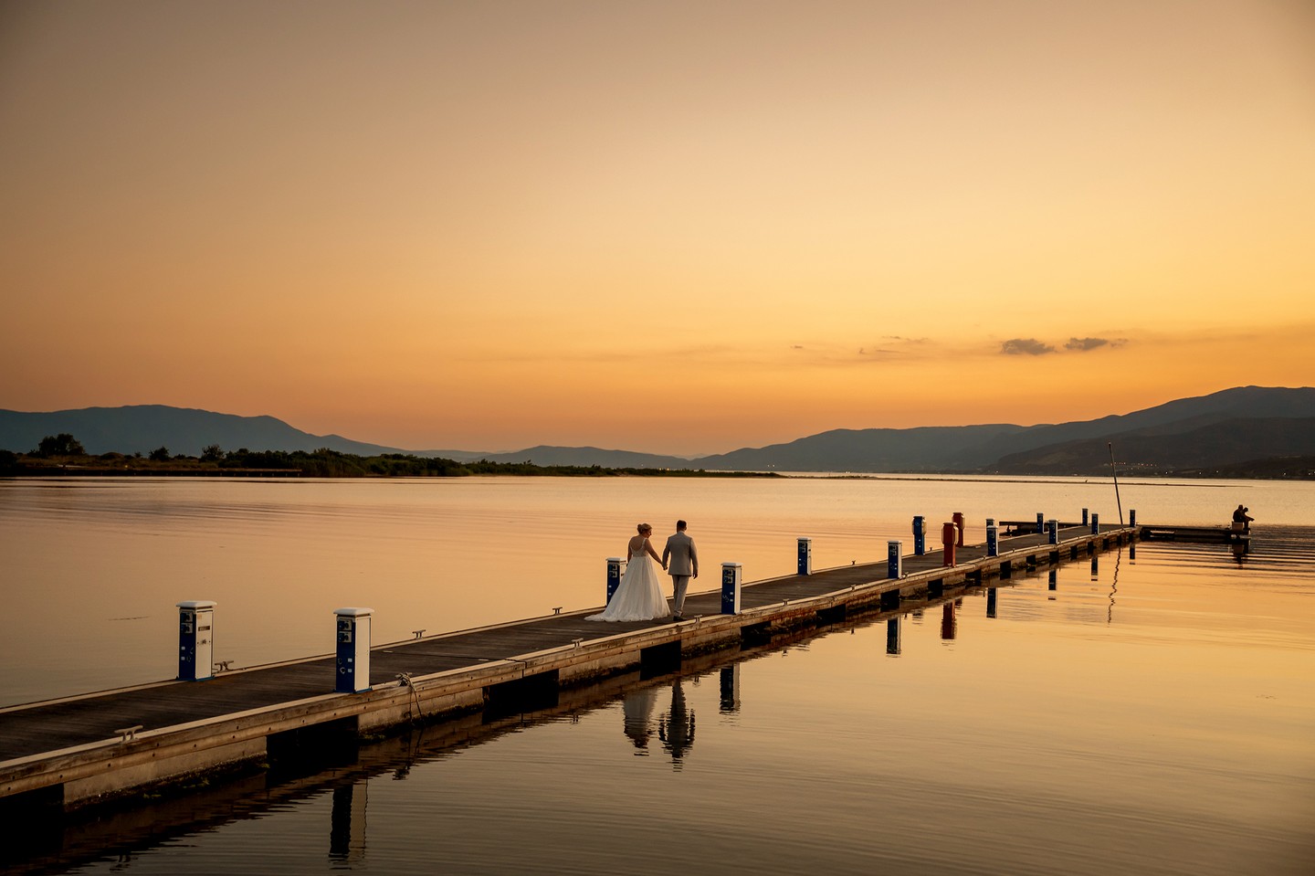 Couple on the pier at sunset